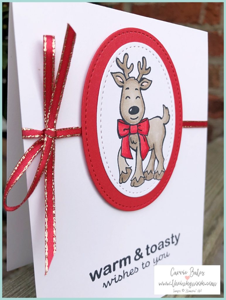 Reindeer Christmas card - a reindeer coloured in brown wearing a red bow die cut into a . Handmade warm and toasty Christmas cards