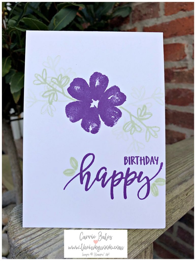 White card stamped with a purple pansy style flower flanked by light green leaf stems.  In  the bottom right hand corner 'Happy Birthday' is stamped in dark purple ink.  This is a pretty perennials birthday card using Stampin' Up! products.