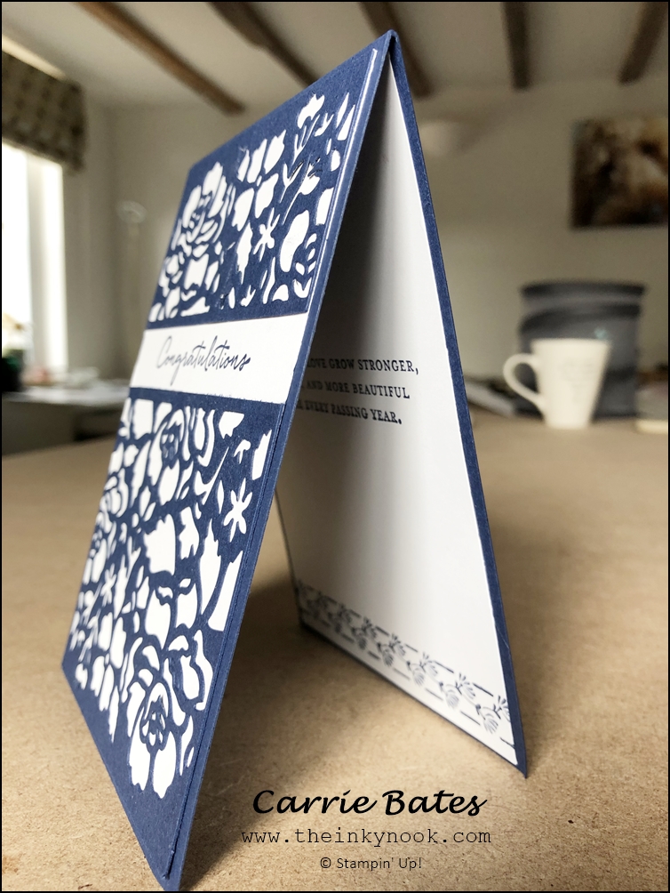 Navy blue detailed floral die cut layer placed on a white card base.  A white banner has been added with the word Congratulations stamped in a navy blue script font. Sapphire wedding anniversary card
