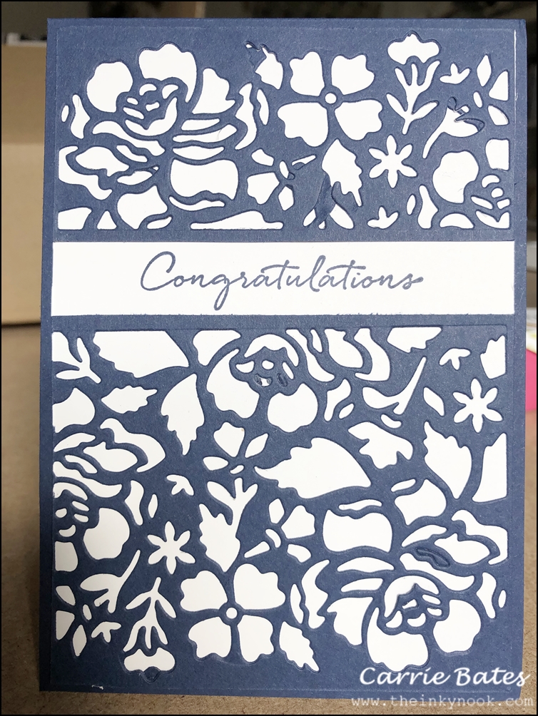 Navy blue detailed floral die cut layer placed on a white card base.  A white banner has been added with the word Congratulations stamped in a navy blue script font.  Sapphire wedding anniversary card
