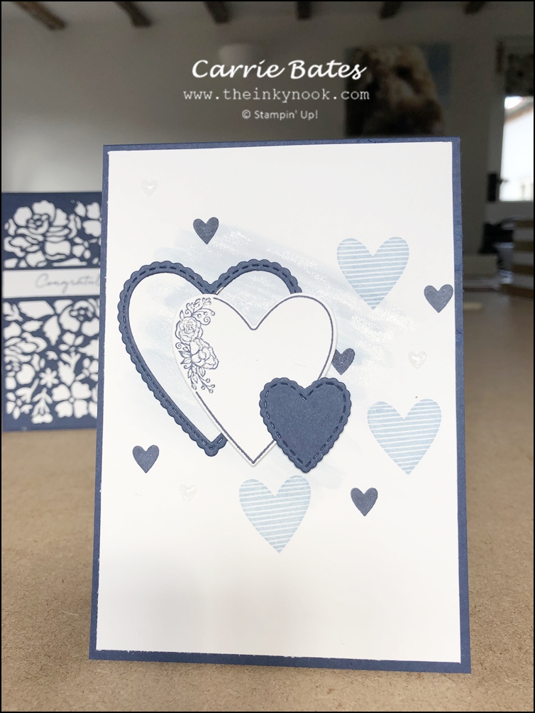 Navy blue card with a white layer decorated with a light blue glittery watercolour wash and topped with light blue and dark blue stamped hearts.  Three white and blue heart diecuts in descending sizes embellish the front.  Sapphire wedding anniversary card
