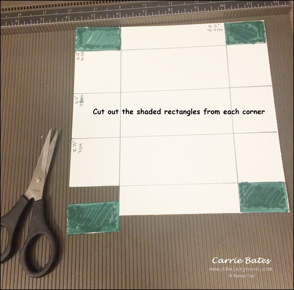 White cardstock marked with lines and measurements to make a triangle box using a scoring board.