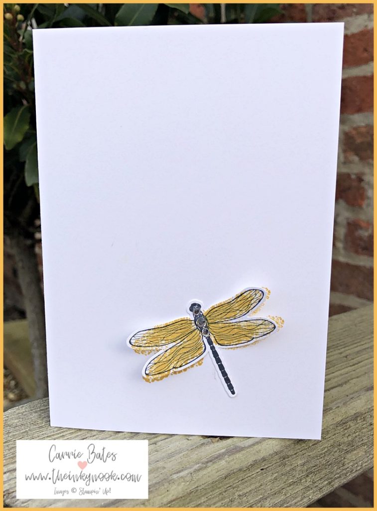 White card with a yellow dragonfly stuck on top with sparkling gems along the body.  See the rest of the blog post for a pop up card. 