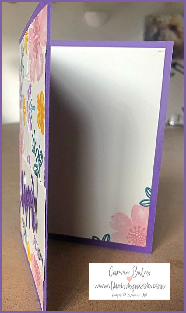 Inside layer of a handmade floral birthday card showing a vanilla layer stamped with a pink pansy style flower and centre with some partial green leaves showing either side.
