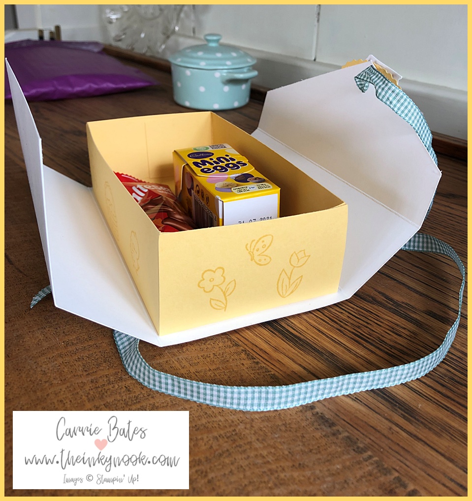 Open view of a white handmade Easter gift box with a yellow centre wrapped in mint gingham ribbon stamped with flowers and butterflies
