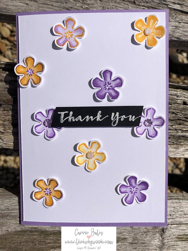 Floral birthday card made using sweet strawberry stamp set and small bloom punch.  Yellow and purple flowers randomly scattered over the card with a white embossed 'thank you' sentiment on black cardstock