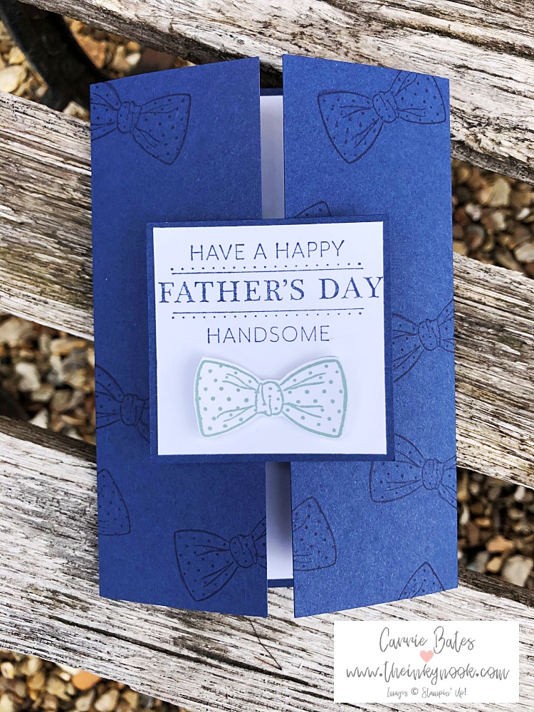 Navy blue gate fold card stamped with navy bowties.  Sliding lock topped with white layer saying "have a happy father's day handsome" with a cut out stamped bowtie image below. Perfect card for father's day