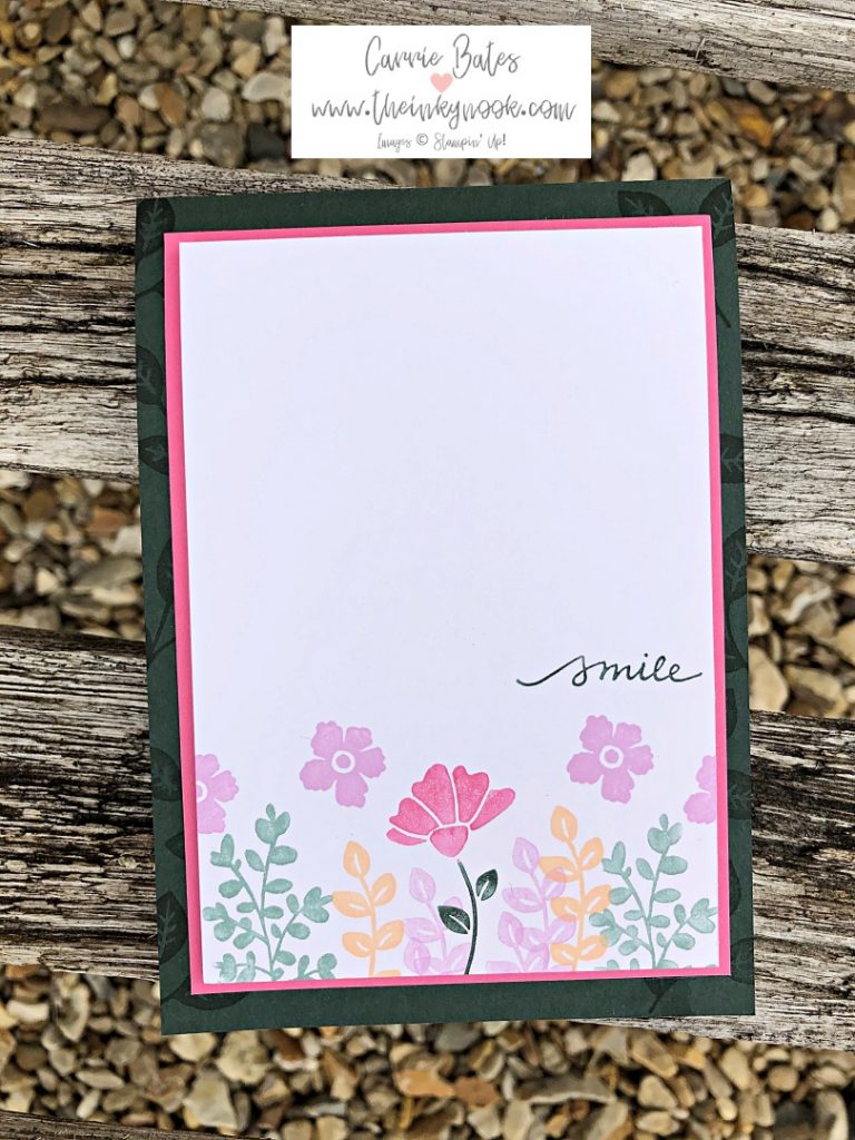 New 2021-23 in colours "smile" card.  Dark green card base with pink layer topped with white layer.  The white layer is handstamped with leaves and flowers in different colours