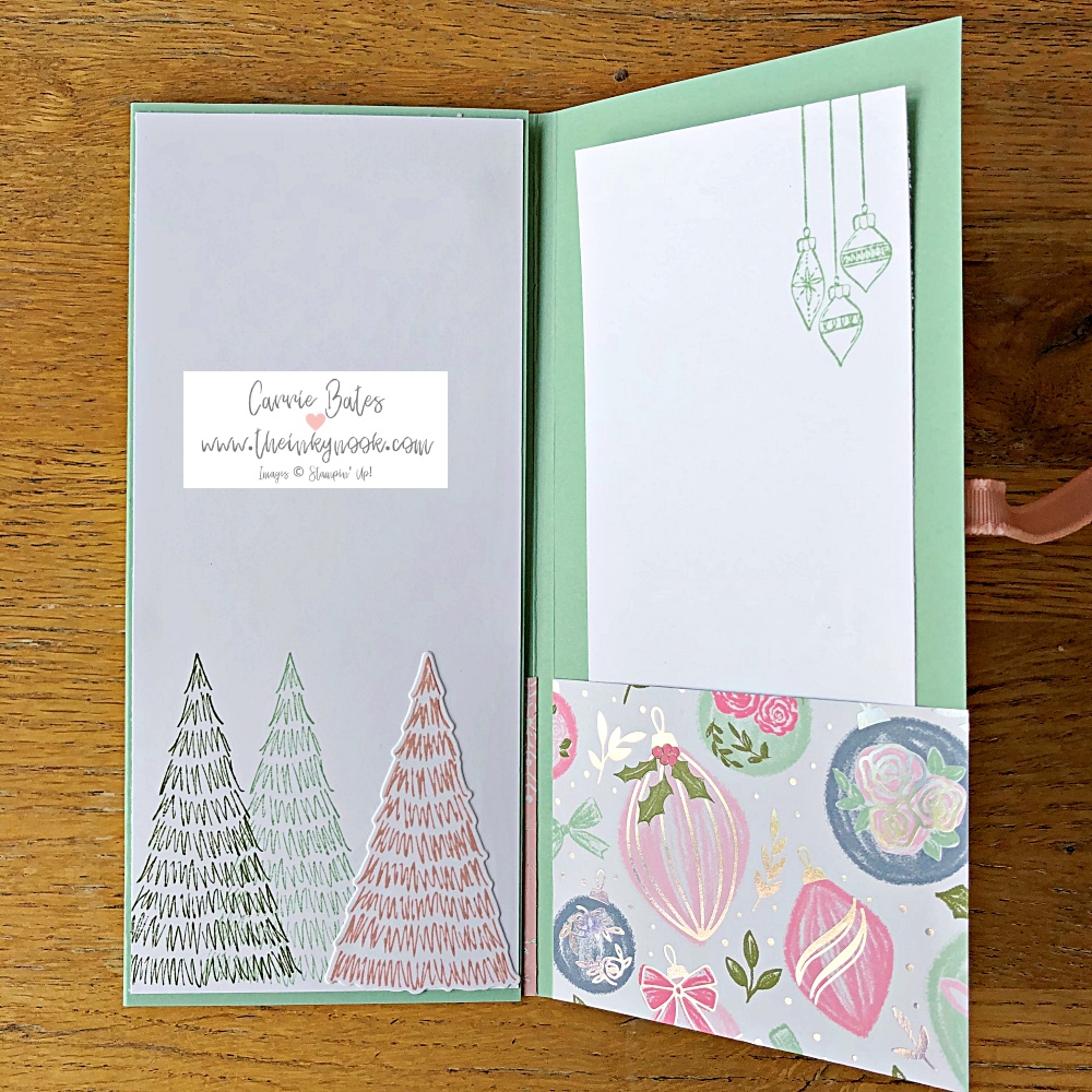 Partial view of tri-fold card in a mint colour with 3 pockets with Christmas patterns and 3 lists inserted behind