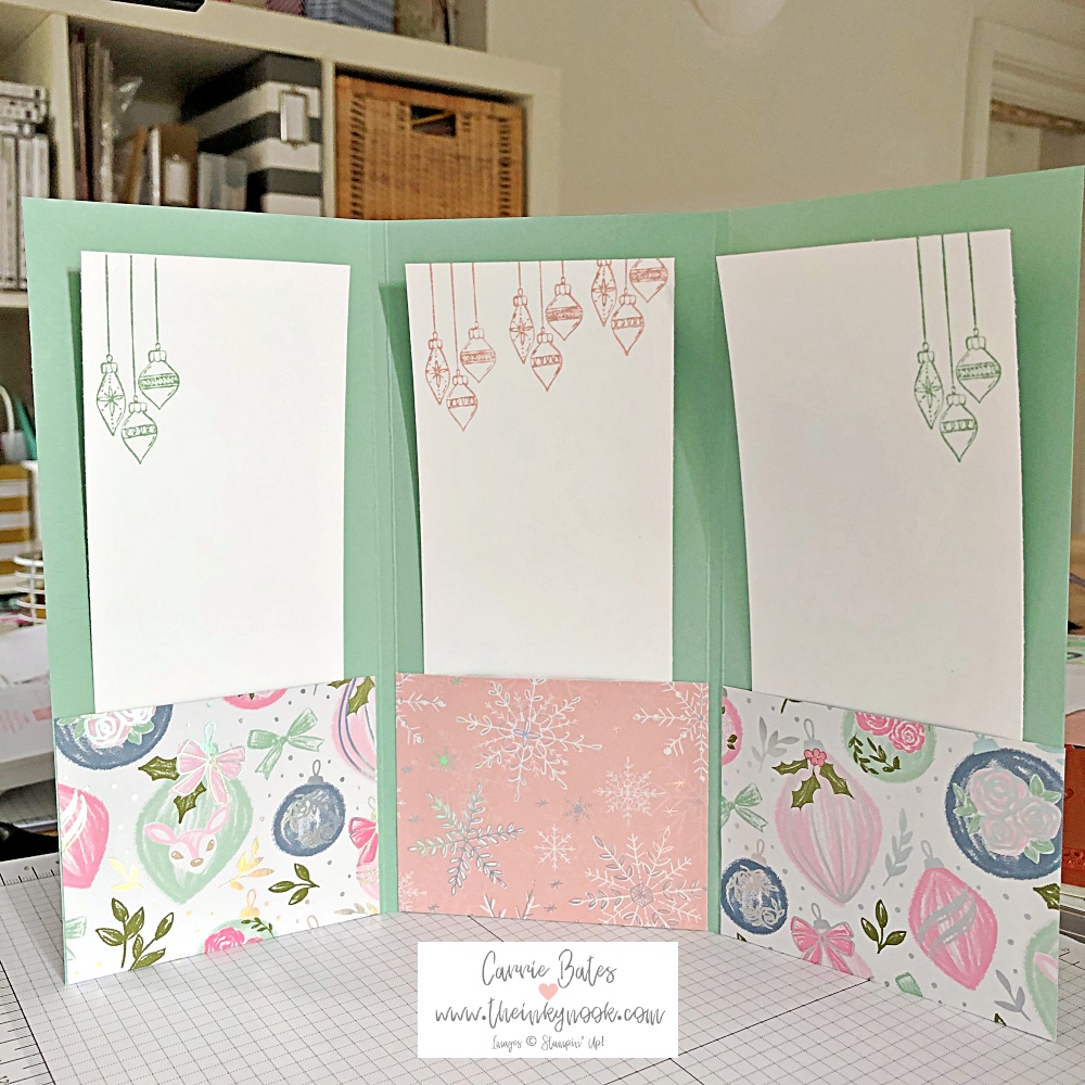 Inside view of tri-fold card in a mint colour with 3 pockets with Christmas patterns and 3 lists inserted behind