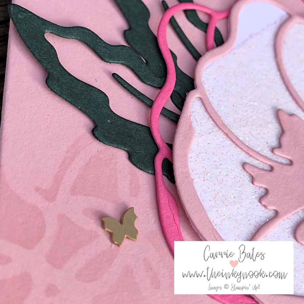 Close up of brushed brass butterfly 3D embellishment on pink card base