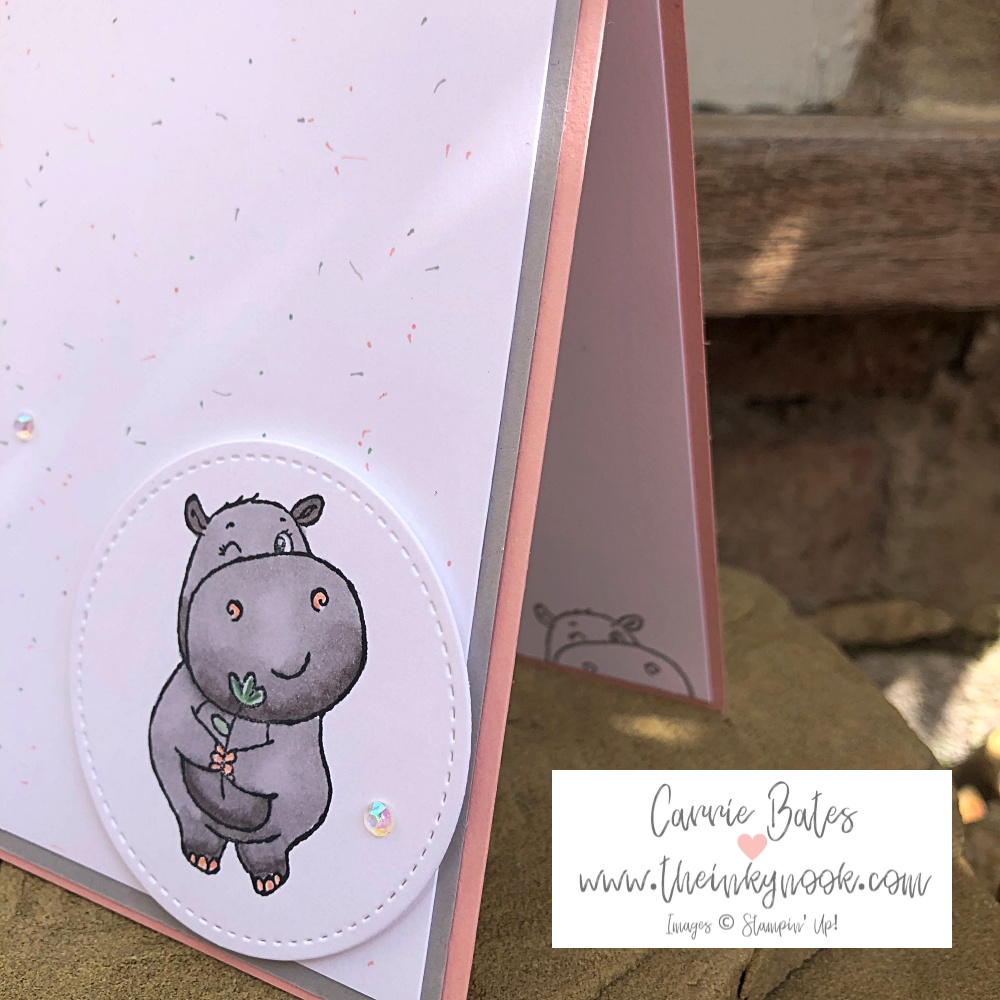 Cardmaking with your favourite colours blog and picture shows a grey hippo holding a flower stamped onto white card on top of a pink card base.