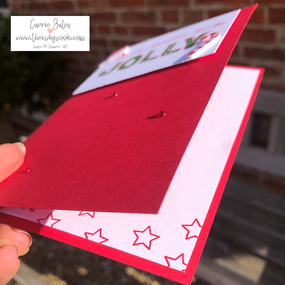 Inside of a simple christmas card showing red stars stamped along the bootom edge of the card insert.