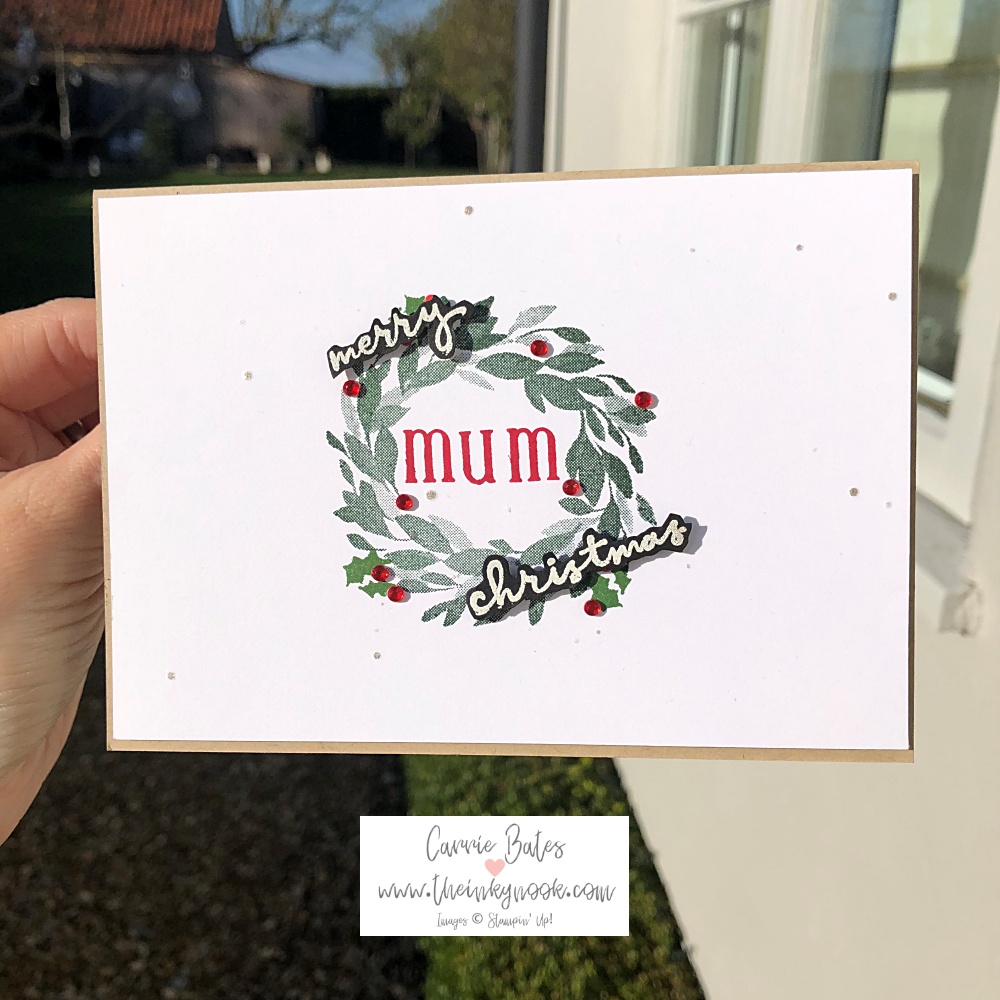 Family Christmas card for a mum showing a green leaf wreath with red rhinestone gems and stamped 'merry christmas mum' greeting