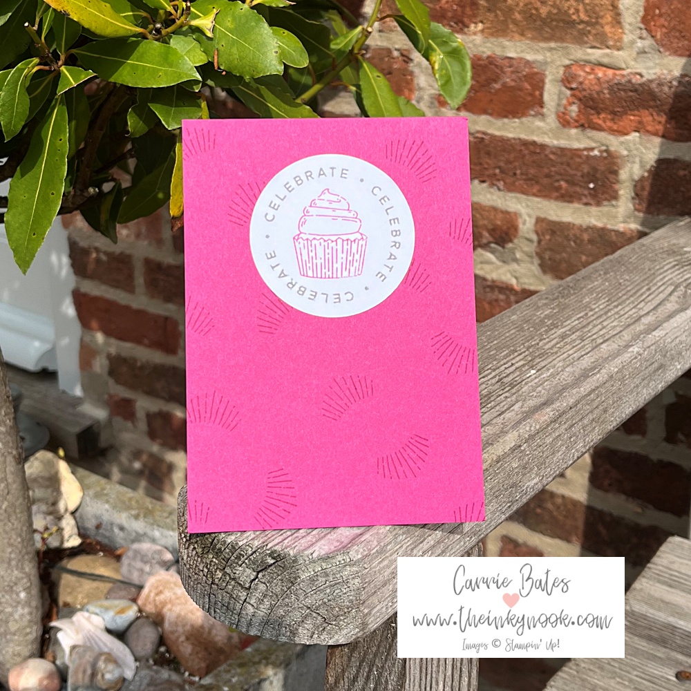 Deep pink coloured card topped with a pink stamped iced cupcake and border in pink spelling "celebrate". A cute cupcake birthday card idea.