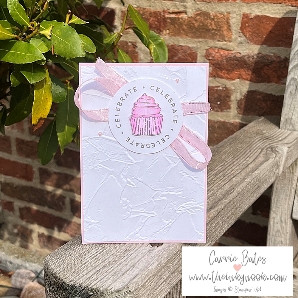Soft pink coloured card topped with a grey and pink stamped iced cupcake and border in grey spelling "celebrate". A cute cupcake birthday card idea.