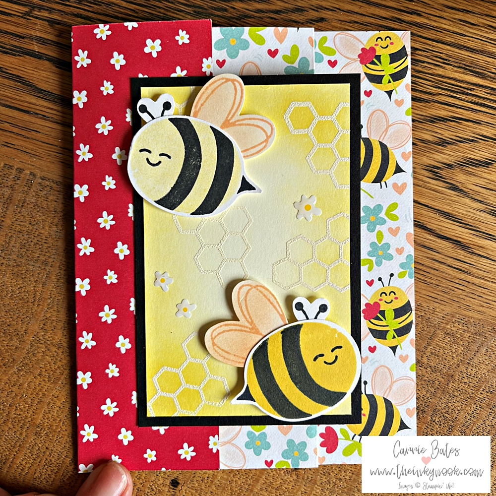 Fun fold accordion card front face showing 2 yellow and black bees flying on front of a yellow embossed honeycomb background