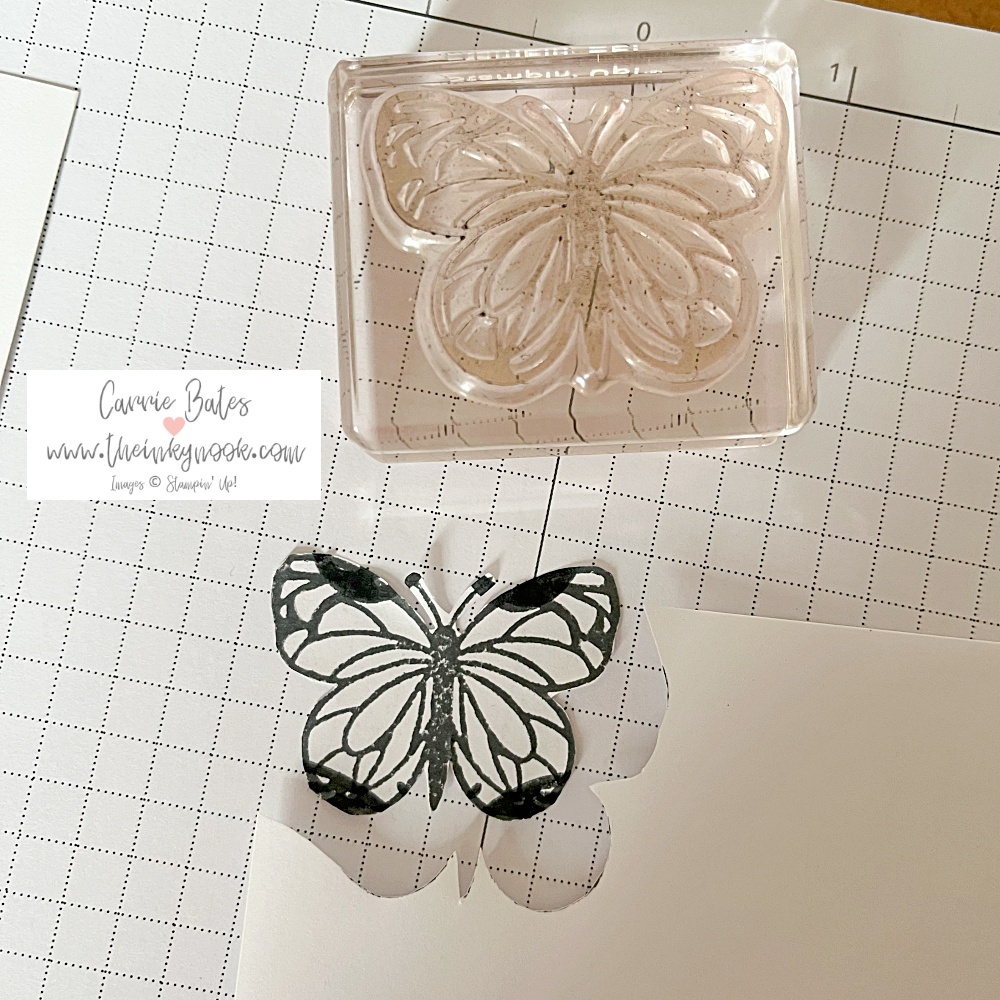 Cut out stamped image of a butterfly using black ink