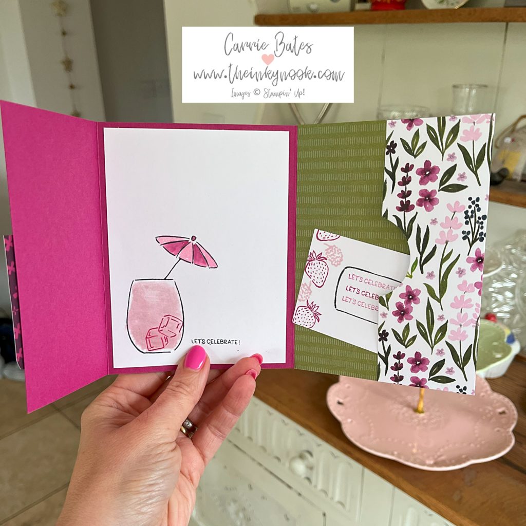 Inside of gate fold card showing a pink glass with ice cubes and a cocktail umbrella. Next to it a flap with wild flowers and a gift card popping out.