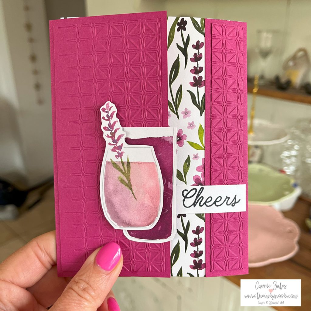 Summer gate fold card using pink purple and green hues. The front has 2 purple cocktails stuck together and then a greeting saying "Cheers" in black ink.